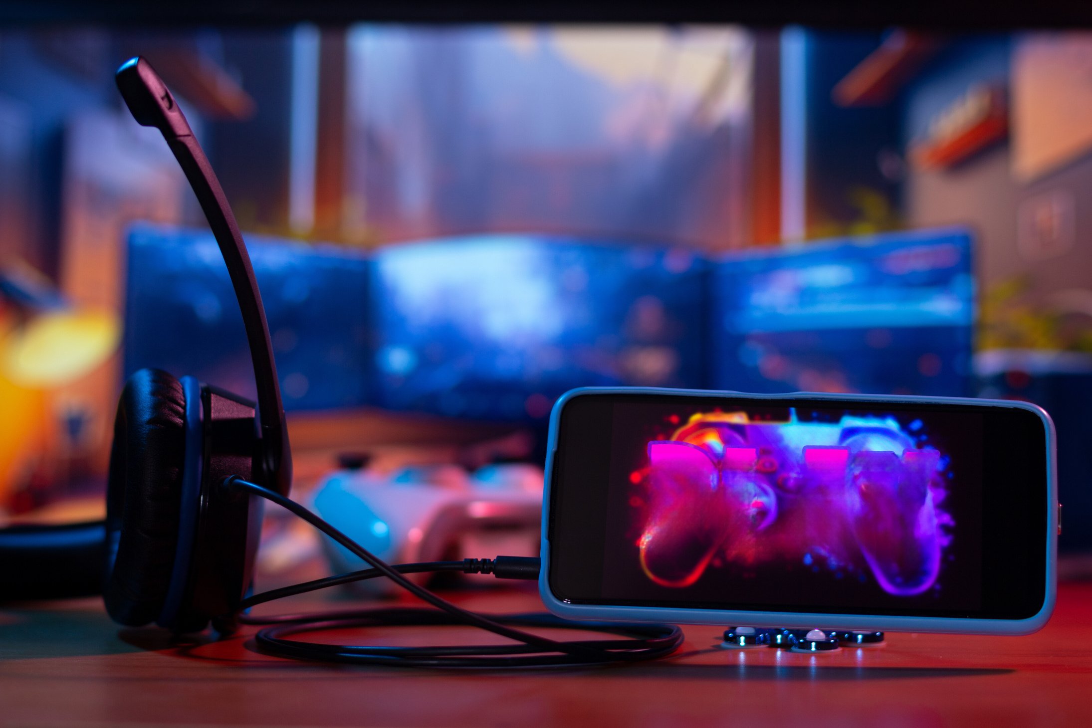 Smartphone gamer setup with video game on display and play button visible